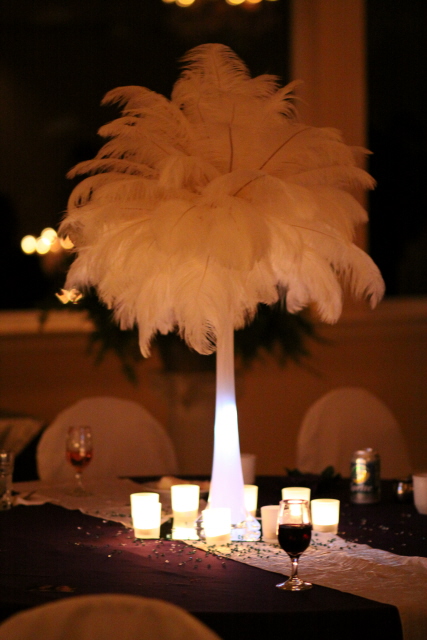 DIY wedding centerpiece was made out of white ostrich feathers
